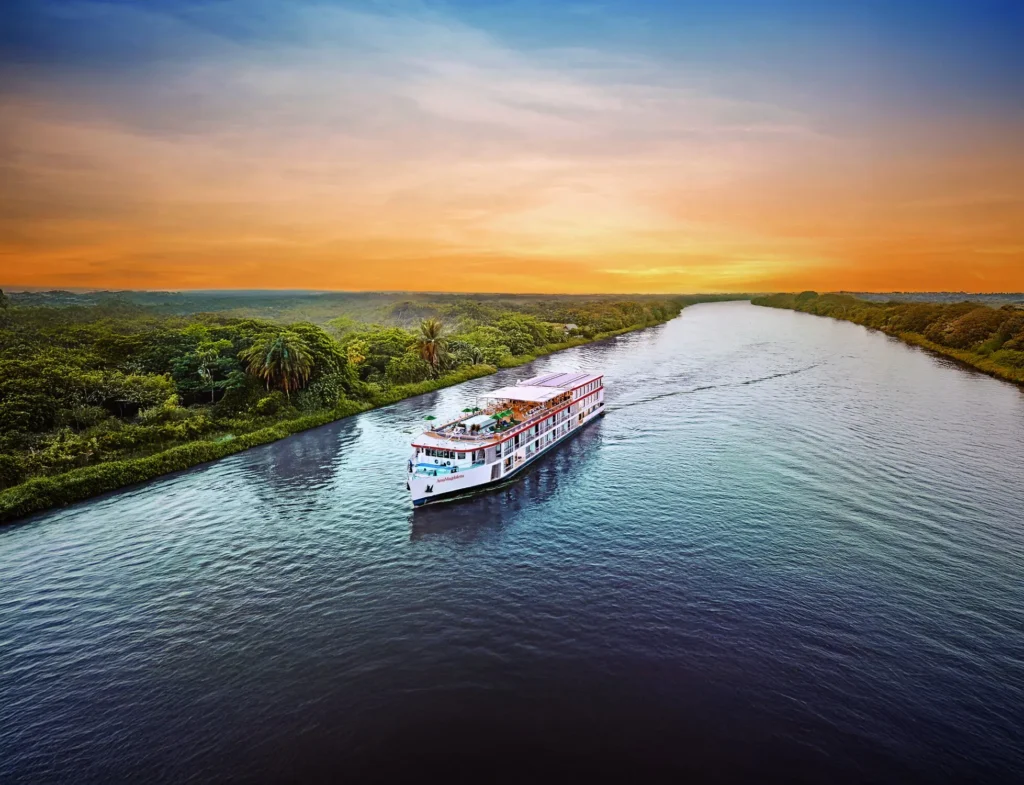 AmaWaterways river cruise ship sailing along a calm river at sunset