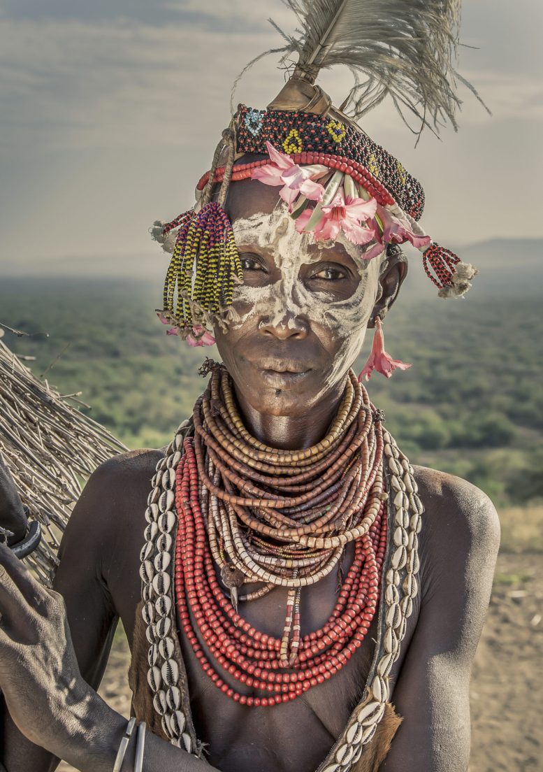 Portrait of mature woman from Karo tribe wearing traditional costume, Ethiopia, Africa